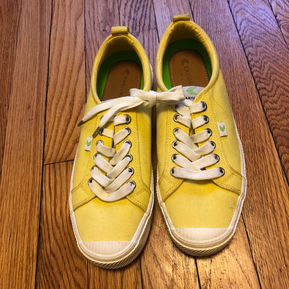 Gently worn yellow Cariuma sustainable shoes